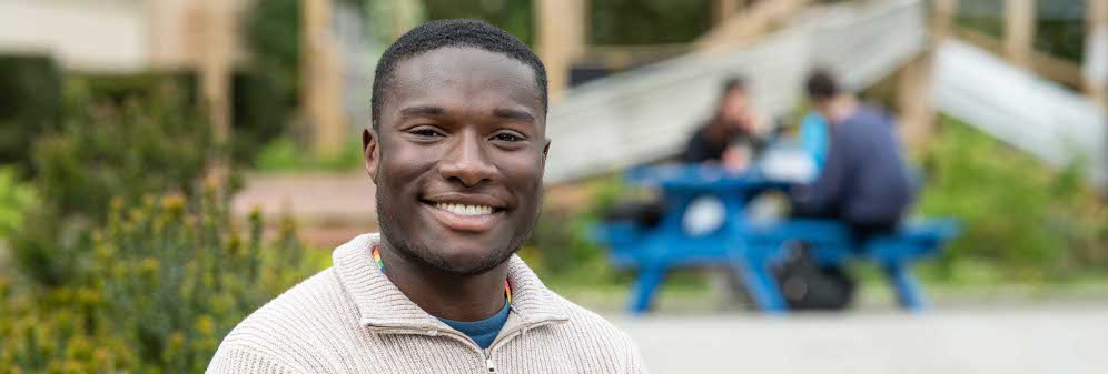 Jayden, a Black Bristol Scholar, sat outside in Bristol.